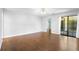 Large living room with hardwood floors, bright neutral paint, and access to outdoor patio at 1120 W Glen Falls Rd, Deland, FL 32720