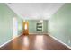 An open living room features a large front window, decorative lighting, and laminate wood flooring at 1120 W Glen Falls Rd, Deland, FL 32720