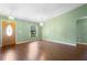 Elegant living room with hardwood floors, modern chandeliers, and a view of the front yard at 1120 W Glen Falls Rd, Deland, FL 32720
