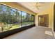 Enclosed patio with view of backyard and ceiling fan at 1120 W Glen Falls Rd, Deland, FL 32720