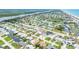 Expansive aerial view of a coastal community with homes, a river, and a sandy beach stretching along the ocean at 114 Ocean Aire N Ter, Ormond Beach, FL 32176