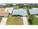 Aerial view highlighting the property's layout, pool, and well-manicured lawn at 114 Ocean Aire N Ter, Ormond Beach, FL 32176