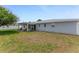 Expansive backyard featuring a well-manicured lawn and covered patio area at 114 Ocean Aire N Ter, Ormond Beach, FL 32176