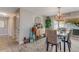 Elegant dining room with stylish light fixture and wood table with seating for six at 114 Ocean Aire N Ter, Ormond Beach, FL 32176