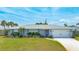 Charming single-story home with light blue exterior, well-maintained landscaping, and attached two-car garage at 114 Ocean Aire N Ter, Ormond Beach, FL 32176