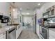 Modern kitchen with stainless steel appliances, granite countertops, and white cabinets at 114 Ocean Aire N Ter, Ormond Beach, FL 32176