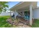 Inviting covered patio with comfortable seating and well-maintained landscaping at 114 Ocean Aire N Ter, Ormond Beach, FL 32176