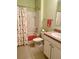 Cozy bathroom featuring a shower with flamingo curtain and a sink with marbled countertops at 119 Fishermans Cove Dr, Edgewater, FL 32141