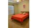 Bedroom with a wooden bed frame, orange linens, a window with blinds, and walls at 119 Fishermans Cove Dr, Edgewater, FL 32141