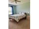 A spacious bedroom features a large bed, a nightstand and a big window to let in sunlight at 119 Fishermans Cove Dr, Edgewater, FL 32141