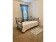 Cozy bedroom featuring metal bedframe and patterned rug with blue curtains at 119 Fishermans Cove Dr, Edgewater, FL 32141