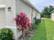 Exterior view of the home with plants and manicured lawn, enhancing the curb appeal at 119 Fishermans Cove Dr, Edgewater, FL 32141