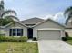 Charming single-story home with a well-maintained front yard, featuring a two-car garage at 119 Fishermans Cove Dr, Edgewater, FL 32141
