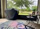 Screened patio with covered grill, table, and chairs overlooking a green lawn at 119 Fishermans Cove Dr, Edgewater, FL 32141