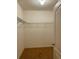 An empty walk-in closet with neutral-colored carpet, wire shelving, and a door at 119 Fishermans Cove Dr, Edgewater, FL 32141