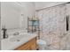 A bathroom featuring a wood vanity and a marble-like shower curtain with chrome hardware at 1191 Tracy Dr, Port Orange, FL 32129