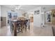 Open dining room with tile flooring and view of kitchen area and backyard at 1191 Tracy Dr, Port Orange, FL 32129