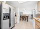 Kitchen with stainless steel refrigerator, tile flooring, and view of the dining room at 1191 Tracy Dr, Port Orange, FL 32129