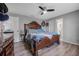 A traditionally designed main bedroom featuring an ornate wood frame bed set, dresser and ceiling fan at 1191 Tracy Dr, Port Orange, FL 32129