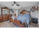 A traditionally designed main bedroom featuring an ornate wood frame bed set, dresser and ceiling fan at 1191 Tracy Dr, Port Orange, FL 32129