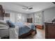 A traditionally decorated main bedroom, featuring a queen bed, with wood laminate flooring and neutral wall colors at 1191 Tracy Dr, Port Orange, FL 32129