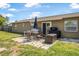 Outdoor patio area with seating, a grill, and a covered storage bin, great for entertaining at 1191 Tracy Dr, Port Orange, FL 32129