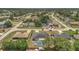 Wide aerial view of neighborhood featuring single Gathering homes, mature trees, and a glimpse of distant horizon at 1194 Balfour Dr, Deltona, FL 32725