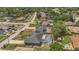 Aerial view of neighborhood highlighting properties with pools and well-maintained lawns in a lush, green surrounding at 1194 Balfour Dr, Deltona, FL 32725