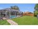 Well maintained backyard with screened in pool, brick patio, and a lush green lawn at 1194 Balfour Dr, Deltona, FL 32725