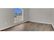 Bedroom featuring a hardwood floor and a large window at 1194 Balfour Dr, Deltona, FL 32725