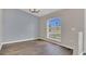 Bright dining room featuring a chandelier, hardwood floors, and a large window at 1194 Balfour Dr, Deltona, FL 32725