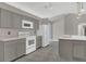 Bright kitchen with stainless steel appliances, gray cabinets, and island with sink at 1194 Balfour Dr, Deltona, FL 32725