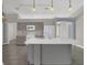 Bright kitchen with stainless steel appliances, gray cabinets, and island with sink at 1194 Balfour Dr, Deltona, FL 32725