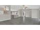 Open-concept living room with tile flooring flows into the kitchen, great for entertaining at 1194 Balfour Dr, Deltona, FL 32725
