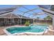 Backyard boasts a screened in pool, brick paver patio, and a safety fence for peace of mind at 1194 Balfour Dr, Deltona, FL 32725