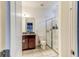 Bathroom featuring single sink with granite countertops, walk-in shower, and tile flooring at 12079 Alder Branch Loop, Orlando, FL 32824