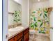 Bright bathroom with a lemon-themed shower curtain and a granite vanity top at 12079 Alder Branch Loop, Orlando, FL 32824