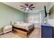 Cozy bedroom featuring a ceiling fan and ample natural light from the window at 12079 Alder Branch Loop, Orlando, FL 32824