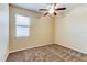 Bedroom features carpet flooring, a large window, and a ceiling fan at 12079 Alder Branch Loop, Orlando, FL 32824
