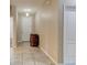Entrance foyer featuring neutral tile flooring, a decorative barrel, and a view into other rooms at 12079 Alder Branch Loop, Orlando, FL 32824