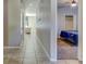 Bright hallway features ceramic tile flooring, leading to a bedroom with carpet and closet at 12079 Alder Branch Loop, Orlando, FL 32824