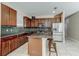 Well-equipped kitchen featuring a center island with seating, modern appliances, and dark wood cabinets at 12079 Alder Branch Loop, Orlando, FL 32824