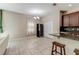 Open kitchen dining area with a large window, wine cooler, pantry and bar seating at 12079 Alder Branch Loop, Orlando, FL 32824