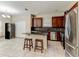 Open kitchen with an island, granite countertops, stainless steel appliances, and dark wood cabinets at 12079 Alder Branch Loop, Orlando, FL 32824