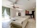 Bright living room with a ceiling fan, tile flooring, and a large sectional sofa open to the kitchen at 12079 Alder Branch Loop, Orlando, FL 32824
