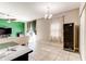 Open-concept living room boasts tile flooring, mini bar, wine cooler, and modern chandelier at 12079 Alder Branch Loop, Orlando, FL 32824