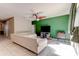 Bright living room featuring tile floors, ceiling fan, and a green accent wall at 12079 Alder Branch Loop, Orlando, FL 32824