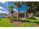 Lush backyard featuring a screened lanai and vibrant landscaping at 1233 Girog Ave, Port Orange, FL 32129