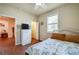 Comfortable bedroom includes closet, window with shutters, and tile floors, combining functionality and style at 1233 Girog Ave, Port Orange, FL 32129