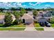 Suburban home with a two-car garage, brick driveway, mature palm trees, and well-maintained lawn and landscaping at 1233 Girog Ave, Port Orange, FL 32129